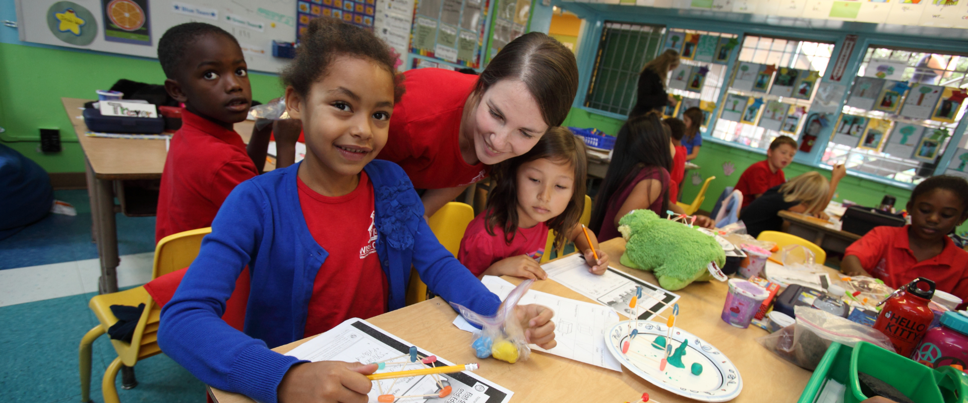 Students and teacher in classroom working on project